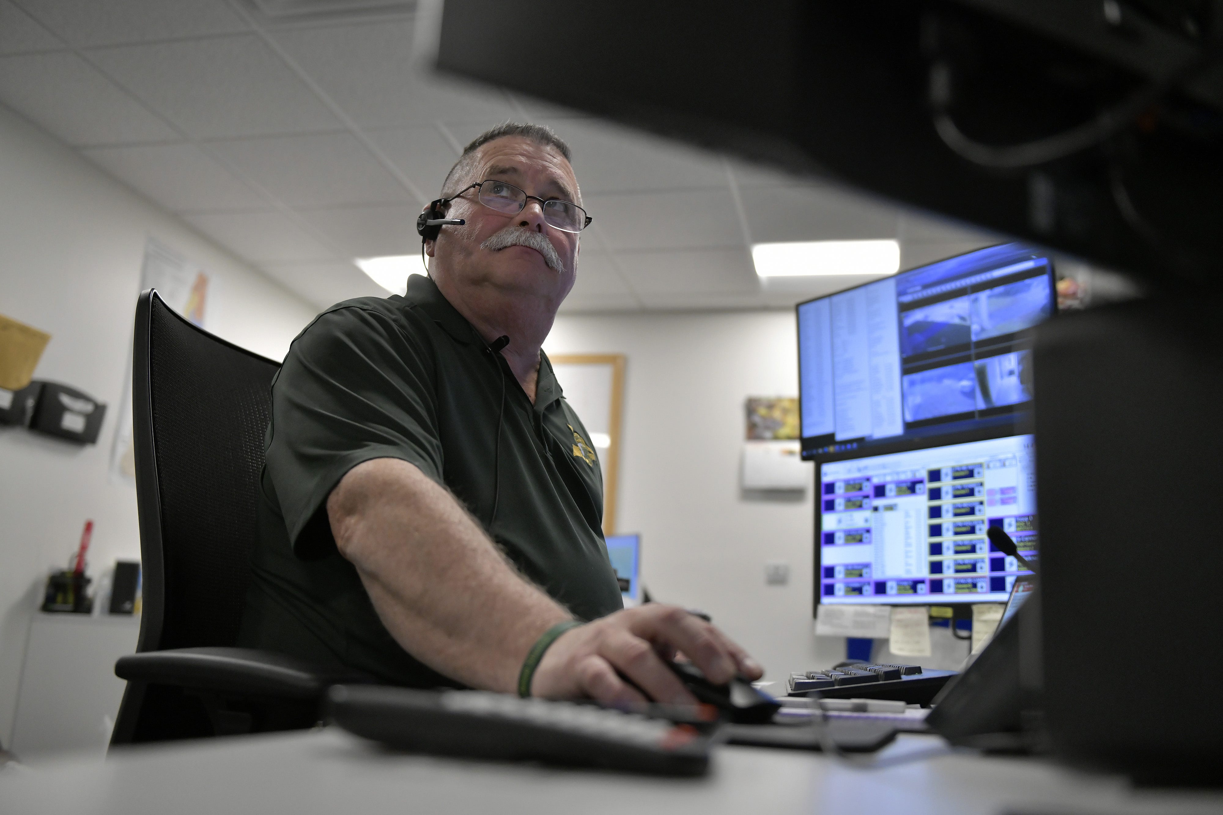 David Miller of Littleton, N.H., 61, a police dispatcher, works a Sunday shift at the NH State Police barracks.