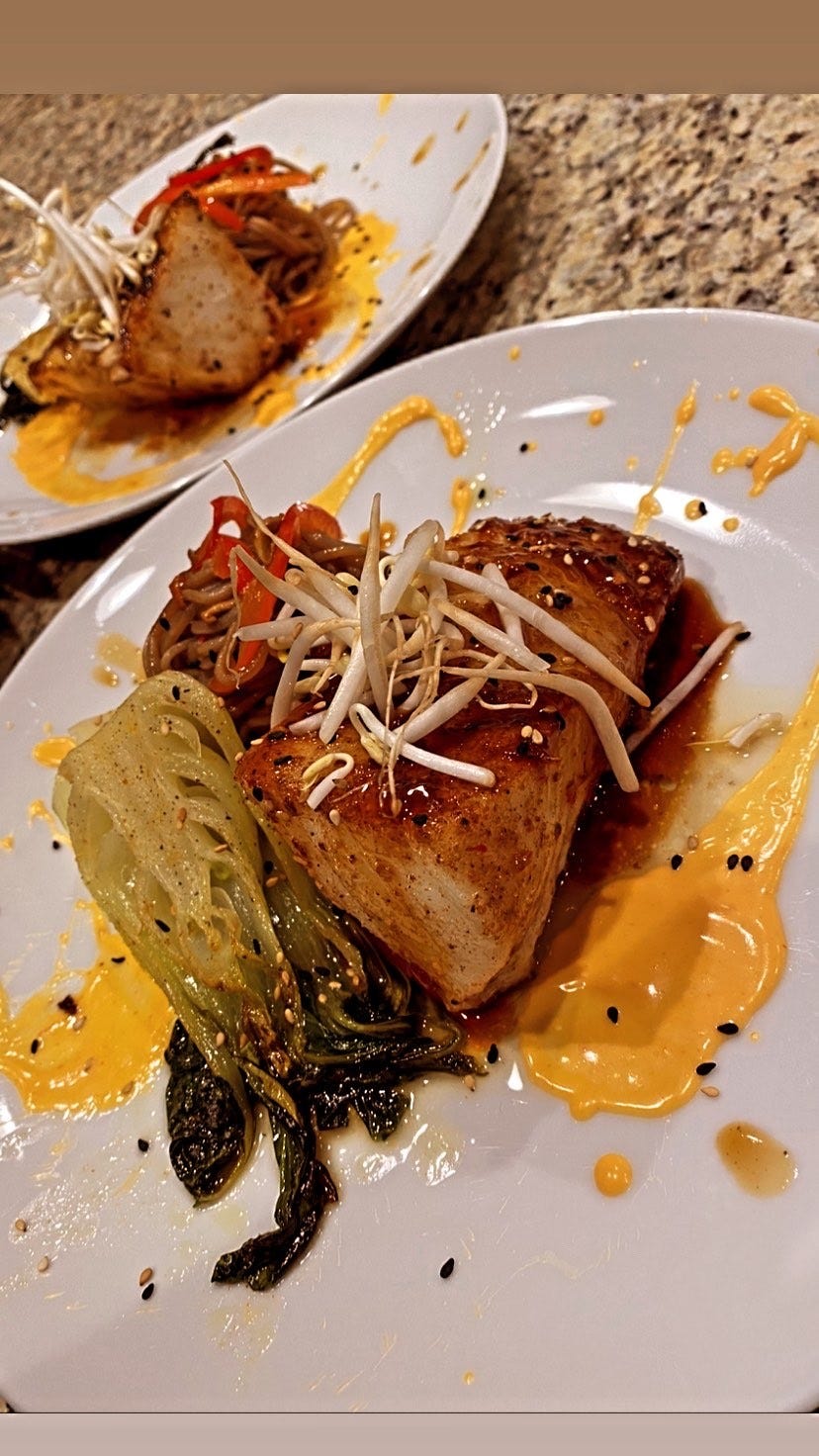 Teriyaki sea bass, brown rice lo mein noodles and grilled baby bok choy over turmeric carrot puree.