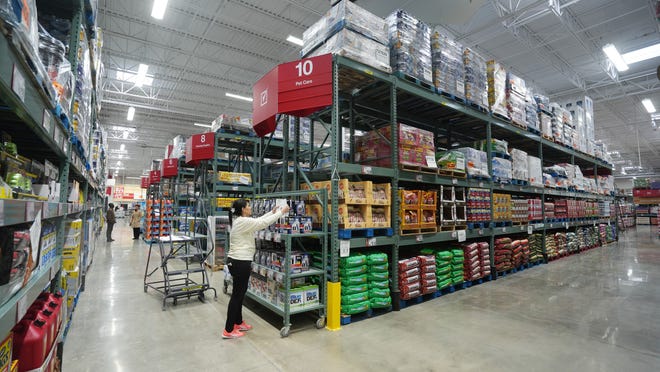 Reme Atallah places signs at BJ’s Wholesale Club as the store opens its newest Ohio location in New Albany, marking its return to the Columbus market after nearly two decades.