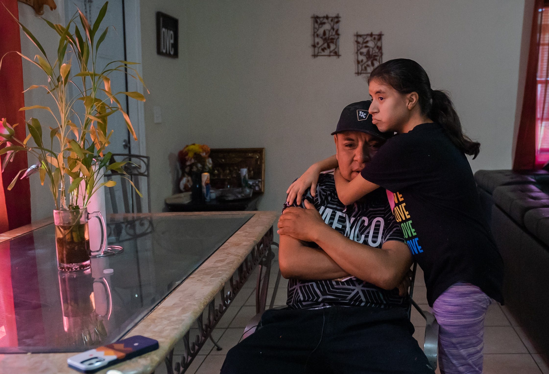 Manuel De La Cruz receives a hug from his 17-year-old daughter, Anahi, after an emotional moment inside their South Bay home. Anahi faces the possibility of having to use a feeding tube for the second time in her life.