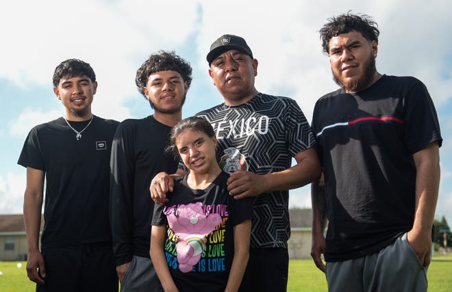 From left, Arturo, 21, Angel, 17, Anahi, 17, Manuel, 43, and Manuel De La Cruz, 23, pose for a picture outside the home of the elder Manuel De La Cruz on Tuesday, November 1, 2022, in South Bay, FL. Manuel Sr. is the sole provider for his family, which includes a special needs child in Anahi, who has Down's syndrome. After losing two fingers during an accident while working, Manuel has had trouble finding steady work.