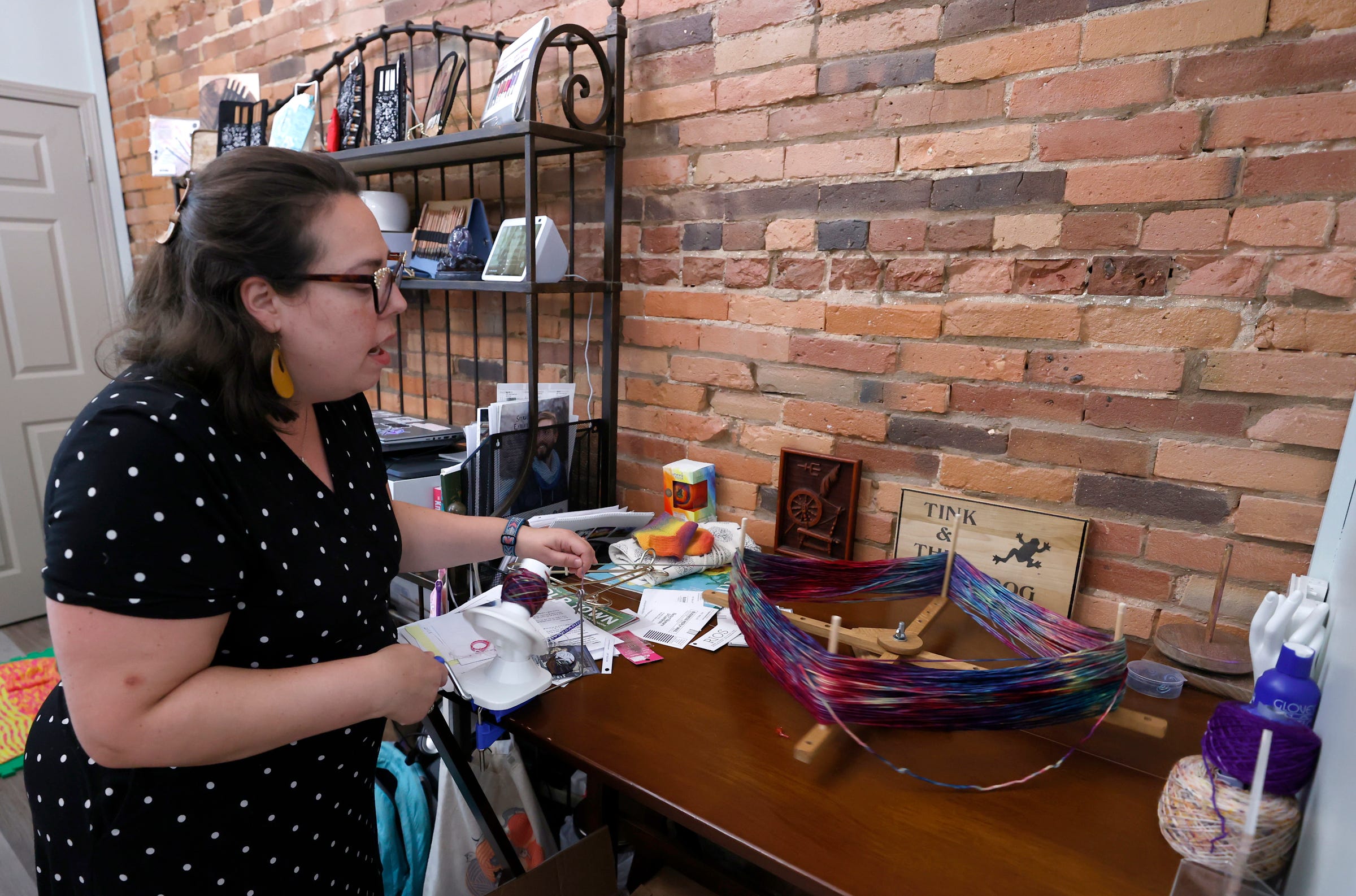 Michelle Beechler, owner of Tink & The Frog, works with getting yarn ready at her knitting store in Adrian on Sept. 1, 2022. Beechler taught at nearby Adrian College but left the school over disagreements with the school administration. She opened her popular store in March 2021.
