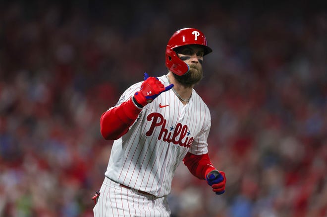 Phillies designated hitter Bryce Harper hits a two-run homer against the Astros in the first inning.