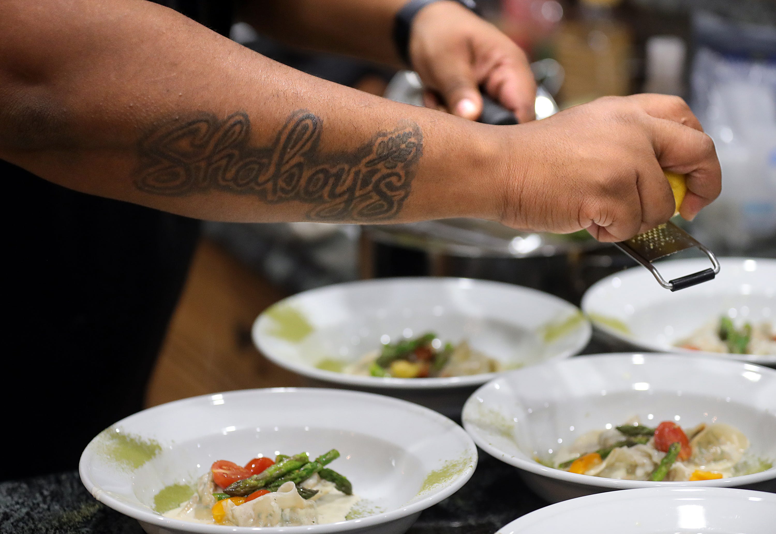 Chef Dion Millender wears his passion on his arm in the form of a tattoo of his company's logo.