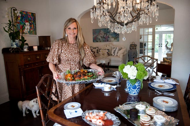 Robin Ganzert, president and CEO of American Humane, serves spatchcock chicken at her West Palm Beach home in November 2021. She has written a cookbook, 'The Humane Table: Cooking with Compassion.'