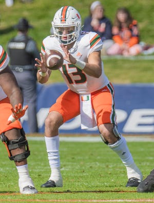 Oct 29, 2022; Charlottesville, Virginia, USA; Miami Hurricanes quarterback Jake Garcia (13) takes a snap in the first half as he was the starting quarterback in the game against the Virginia Cavaliers at Scott Stadium. Mandatory Credit: Lee Luther Jr.-USA TODAY Sports