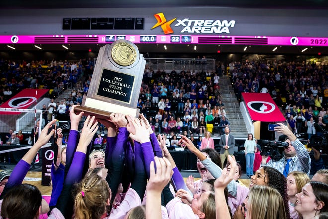 Iowa City Liberty players celebrate with their championship trophy after a Class 5A state volleyball championship match against Pleasant Valley, Thursday, Nov. 3, 2022, at Xtream Arena in Coralville, Iowa.
