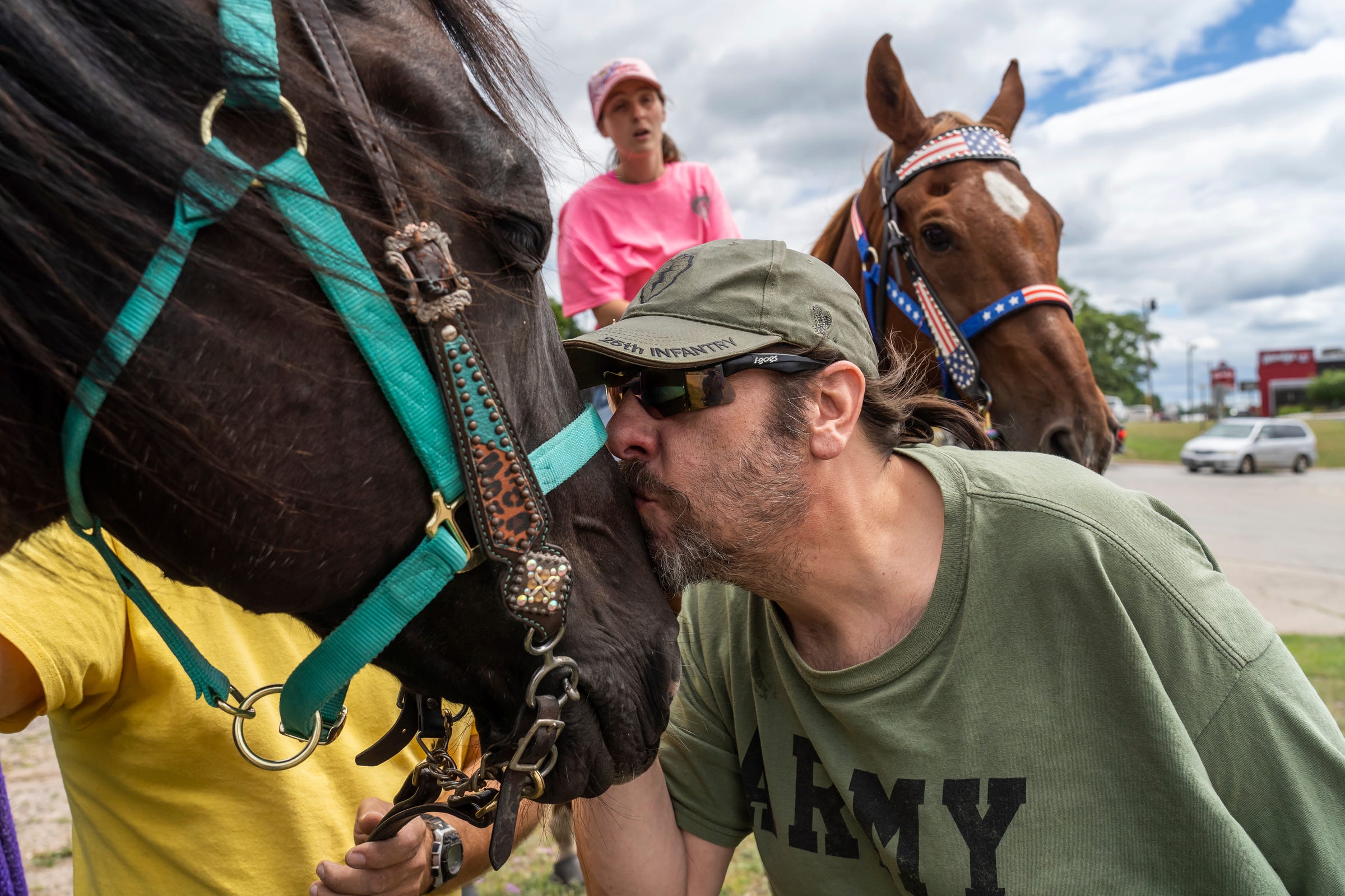 Army veteran Kurt Berger of Iron Mountain kisses Tucker the horse after Steven Pringle, owner of Build a Bicycle - Bicycle Therapy, and his girlfriend Lindsey Gagne of Kingsford brought the horse to Berger's apartment in downtown Iron Mountain to give him a chance to ride them on Friday, July 29, 2022. "I love animals," said Berger, who admitted that he suffers from PTSD. "It takes all my problems away for the moment. I feel so good today that I don’t feel like I need my medication."