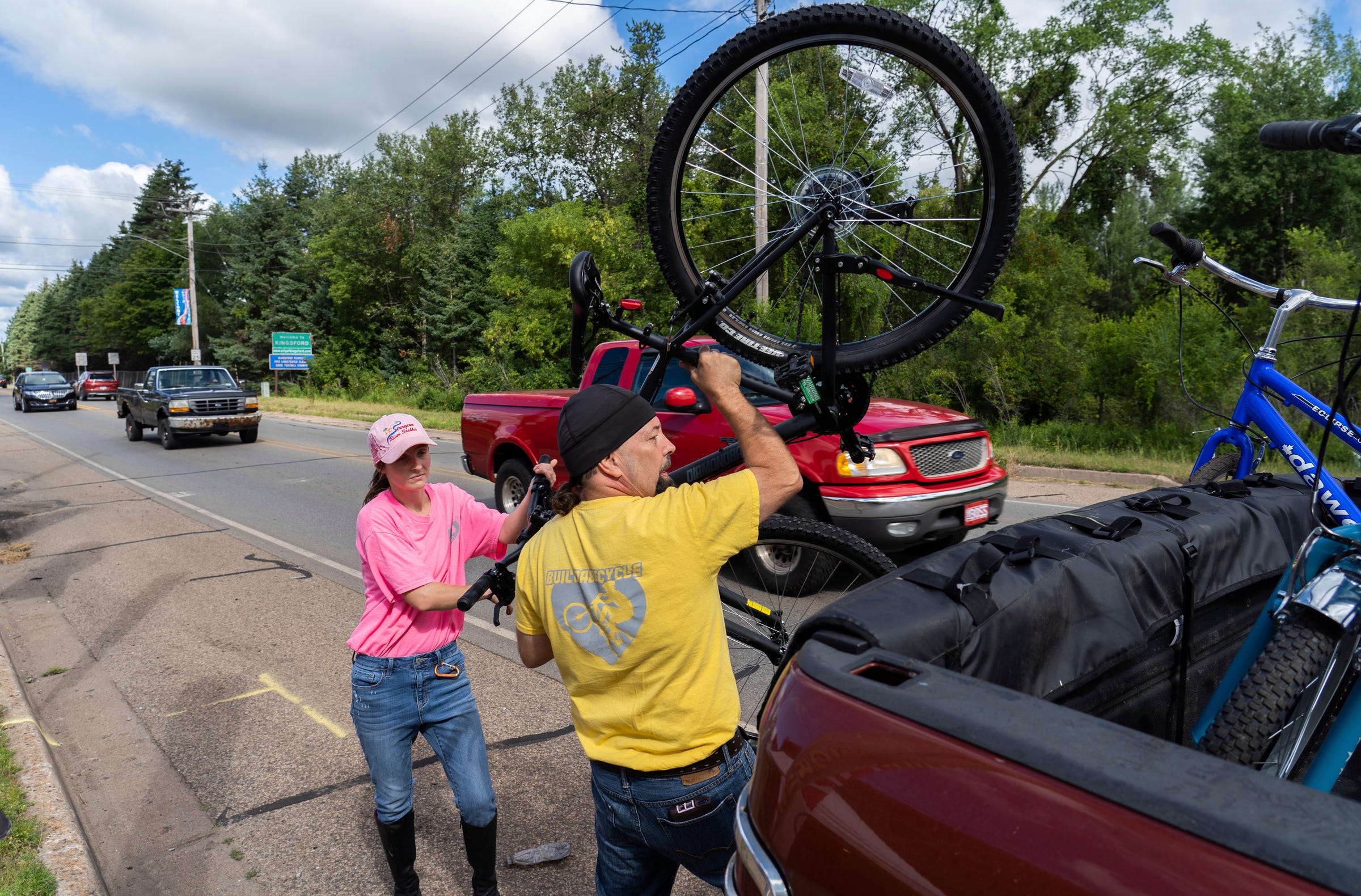 Steven Pringle, owner of Build a Bicycle - Bicycle Therapy, and his girlfriend Lindsey Gagne load bikes into the back of his truck to be donated to nuns of the Carmelite Monastery of the Holy Cross in Iron Mountain on Friday, July 29, 2022. 