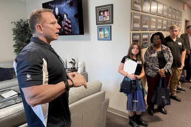 Louis Erickson, chief operating officer of Bit-Wizards, gives a tour off the company's building to a group of visiting Okaloosa County teachers and students on Friday. The group also visited nearby Beast Code and the HCA Florida Fort Walton-Destin Hospital as part of the Educate the Educators Plus One program.