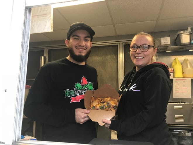 HomeTown Tacos Locos employees Omar A. Cruz and Amber Lewis display some nachos that customers can buy at the food truck which is located next to HomeTown Furnishings on Broadway in Taunton.
(Photo: Taunton Gazette/Ed Baker)