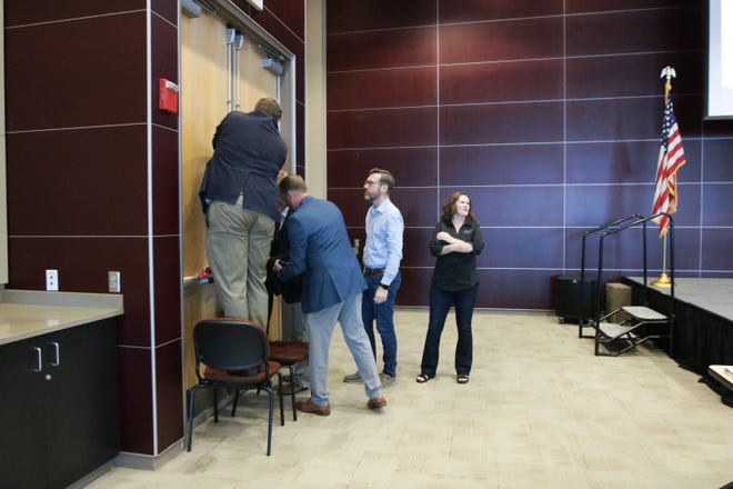 Volunteers were given one minute to barricade doors during a simulation of an active-shooter event during the Bay County Chamber of Commerce First Friday.