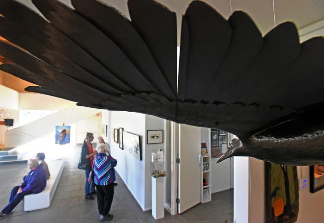 Art enthusiasts admire the works at the Mansfield Art Center during the 2022 Crow Festival exhibit.