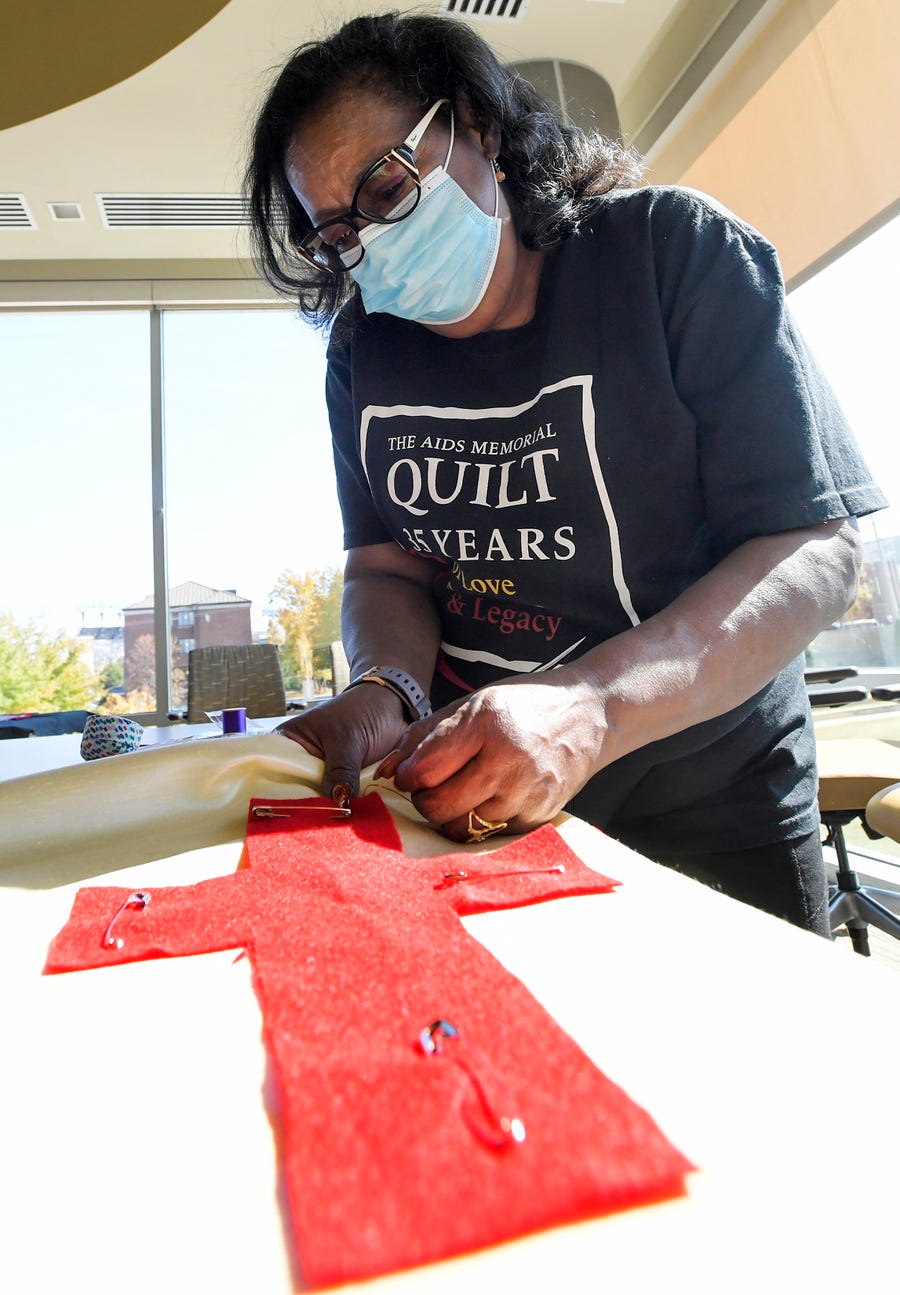 Stephanie Laster works on quilts honoring Black and brown lives lost to HIV/AIDS during the Change the Pattern event held on the Alabama State University campus in Montgomery, Ala., on Friday, Nov. 4, 2022.