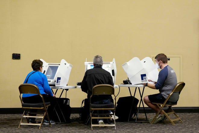 Early voters fill electronic ballots at the Northern Kentucky Convention Center in Covington, Ky., on Thursday, Nov. 3, 2022.