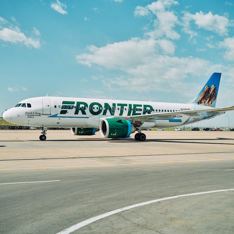 Frontier Airlines planes taxi at Denver Internatio