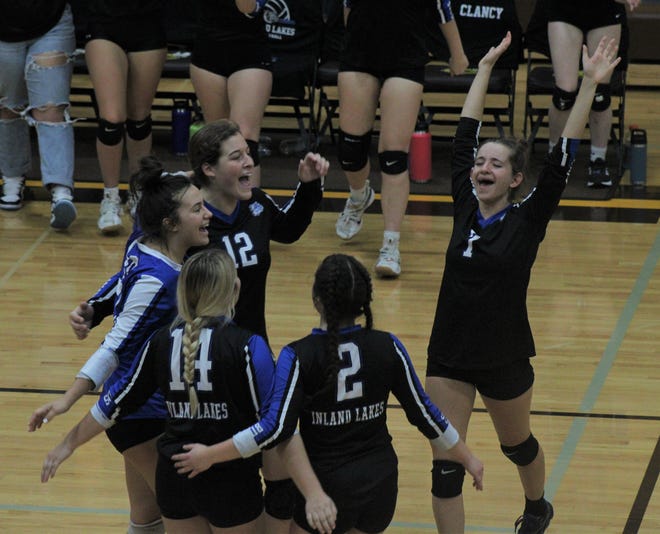 Inland Lakes players Hannah Robinson (7), Erica Taglauer (2), Kaydince Fate (14), Ryann Clancy (16) and Natalie Wandrie (12) celebrate after winning the final point of a MHSAA Division 4 district championship match against Burt Lake Northern Michigan Christian Academy at Pellston on Friday.