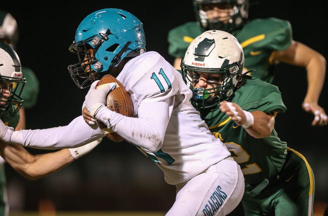 Flat Rock's Andrew Given, comes in for the tackle on Keyan Phillips of Summit Academy Friday night. Flat Rock won 29-28 to capture a District championship.