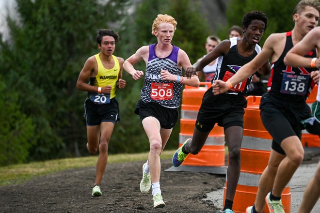 Battle Creek Lakeview's Aiden Moore, center, runs during the Division 1 boys state cross country final on Saturday, Nov. 5, 2022, at Michigan International Speedway in Brooklyn.