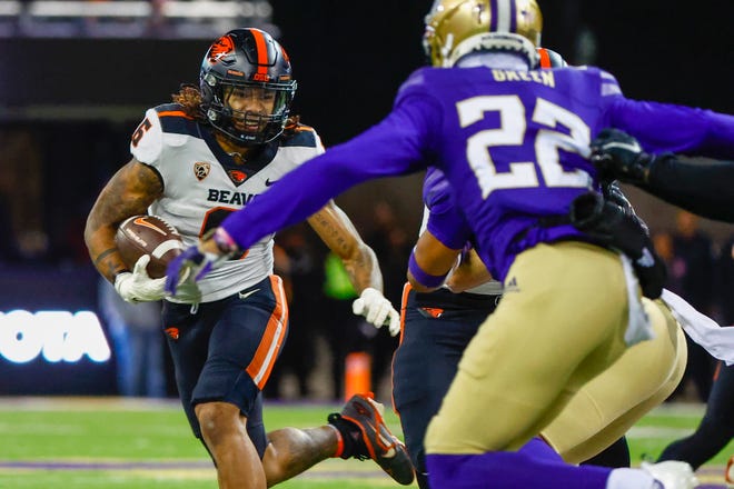 Oregon State Beavers running back Damien Martinez (6) rushes against the Washington Huskies during the third quarter at Alaska Airlines Field at Husky Stadium in Seattle on Friday, Nov. 4, 2022.