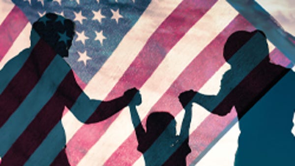 Family silhouetted against American flag