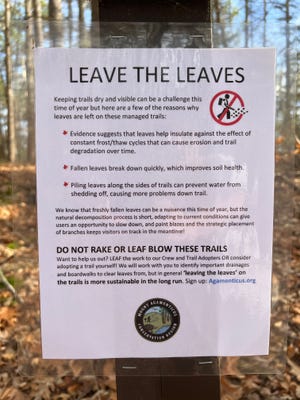 A sign on a trail at Mount Agamenticus in York, Maine, explains why leaves are not being cleared from the trail.