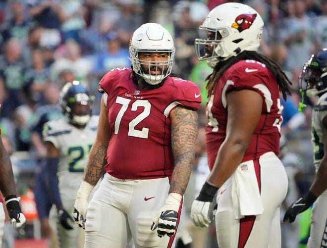 Cody Ford, left, shown playing with the Cardinals against Seattle in November, has signed with the Cincinnati Bengals.