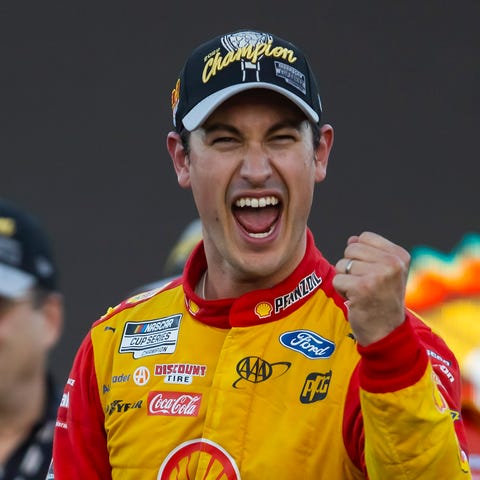 Joey Logano celebrates after winning the 2022 NACA