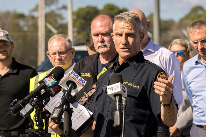 Jacksonville Fire and Rescue Department Public Information Officer Capt. Eric Prosswimmer, center, speaks at a news briefing Monday, Nov. 7, 2022, in Brunswick, Ga. A large fire burned inside a chemical plant where authorities ordered nearby neighborhoods to evacuate because of threats from toxic smoke and potential explosions. Emergency responders safely evacuated a small handful of employees working when the fire broke out at about 4 a.m. Monday at the plant outside the port city of Brunswick, Ga., said Prosswimmer, who was on the scene with fire crews from Jacksonville, Fla., sent to help battle the flames. (AP Photo/Stephen B. Morton)