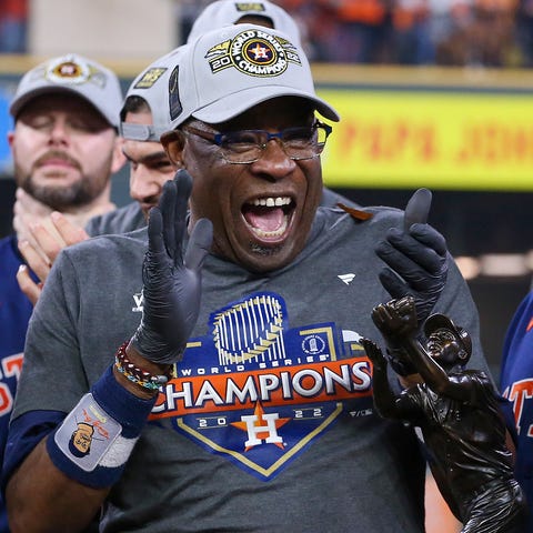 Dusty Baker celebrates on the field after winning 