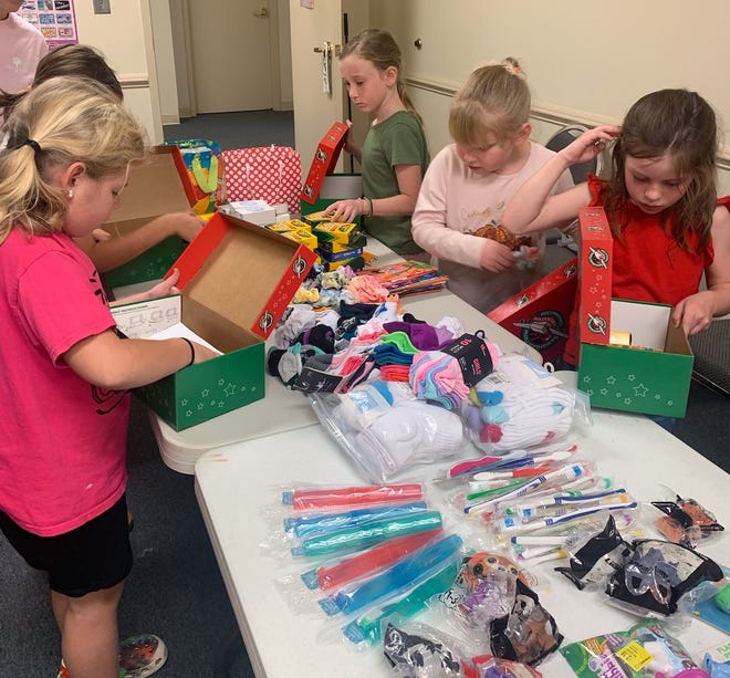 Wrens Baptist Church GAs (Girls in Action) prepare gift boxes for other children around the world as part of Samaritans' Purse's Operation Christmas Child.