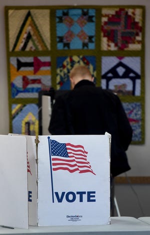 Aiden Davis, 18, votes at Precinct 2 held at St. Paul's United Methodist Church in the City of Monroe on November 8, 2022.