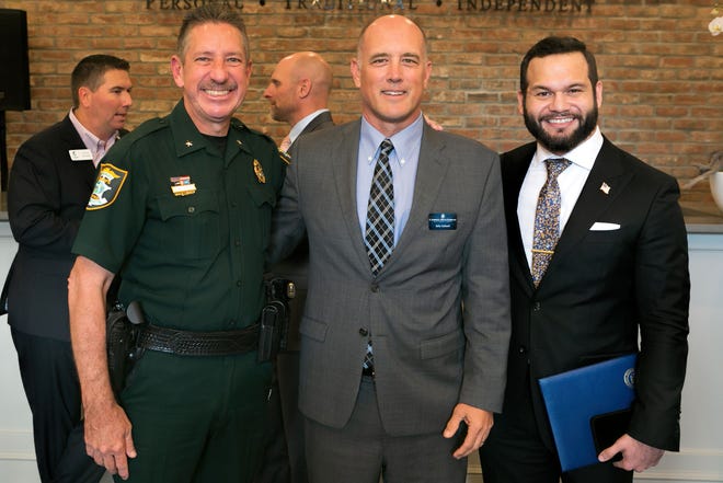 Sarasota County Sheriff Kurt A. Hoffman, left, R.G. “Kelly” Caldwell Jr., CEO/president of Caldwell Trust Co., and Sarasota Mayor Erik Arroyo, at the grand opening.