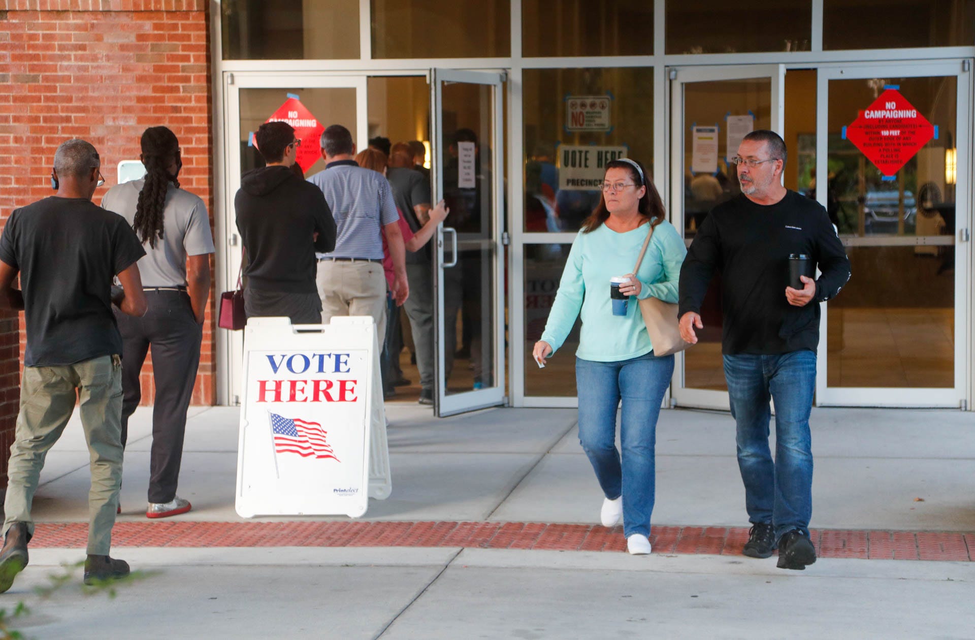 Voters exit Coastal Cathedral Church while around a hundred still wait in line on Tuesday November 8, 2022 in Savannah Georgia.