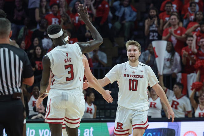 Rutgers Scarlet Knights guard Cam Spencer (10) is congratulated by teammates after a basket against the Columbia Lions during the second half at Jersey Mike's Arena.