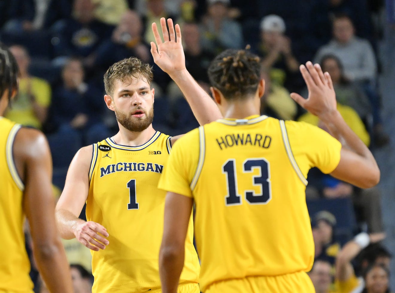 Michigan center Hunter Dickinson (1) and guard Jett Howard (13) high five in the second half.