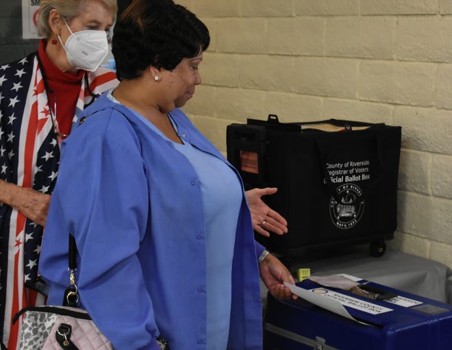 A resident of Desert Hot Springs drops her ballot in the ballot box during the 2022 elections at the Desert Hot Springs Senior Center in Desert Hot Springs, Calif., on November 8, 2022.