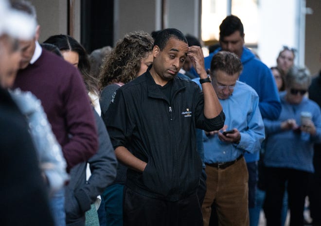 Voters wait in line on Nov. 8, 2022, at the Biltmore Fashion Park in Phoenix.