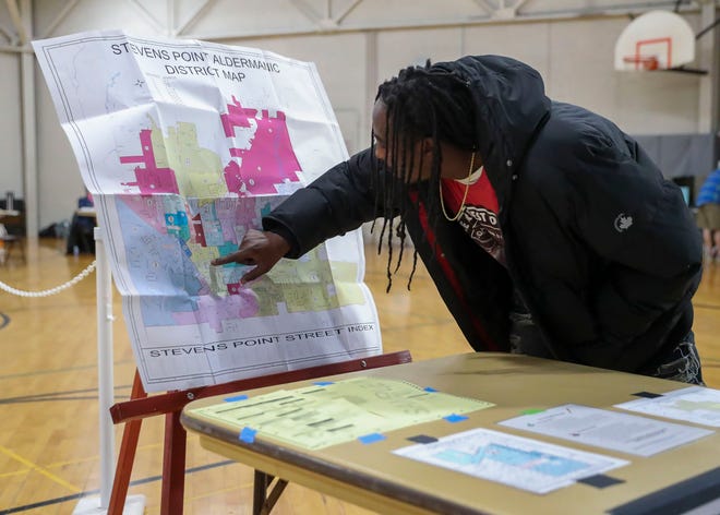 Raymond Sally checks the district map to find his ward number on Nov. 8 at the Stevens Point Recreation Center in Stevens Point.