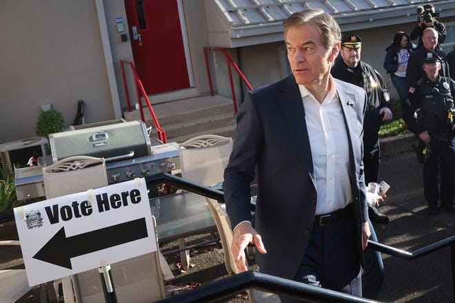 Republican U.S. Senate candidate Dr. Mehmet Oz enters the polling station at the Bryn Athyn Borough Hall to cast his ballot on Nov. 8, 2022 in Huntingdon Valley, Pennsylvania. Oz faces Democratic Pennsylvania Senate nominee John Fetterman in midterm elections taking place across the United States today.