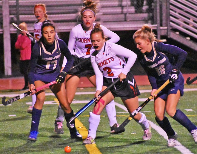 Jillian Hoey (2), Lily Murray (7) and Alyssa Czekai (5) of Honesdale converge on the ball during opening round action of the PIAA state field hockey tournament.