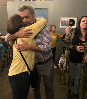 Rep. Jason Probst, D-Hutchinson, shares a hug with Sarah McKinnon after learning he'd won re-election at a watch party Tuesday night at Sandhills Brewing.