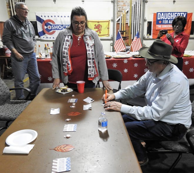 Grant Daugherty writes down final numbers for the Coshocton County Auditor's race during an election night party at the Historic 1908 Fire Station. The Republican defeated incumbent Democrat Chris Sycks in Tuesday's general election.