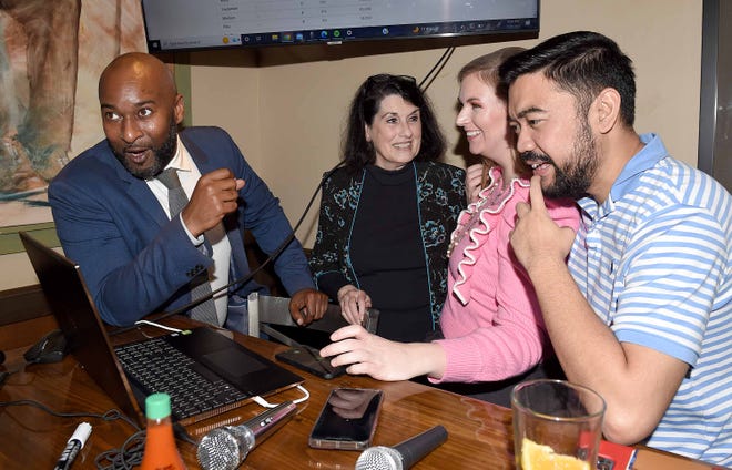 Third District Democrat candidate Shuwaski Young (far left) watches vote tallies with supporters (from right) Jade Gales, Brittney Gales and Susan Weatherholt at an election night party at Soulshine Pizza in Flowood on Tuesday, Nov. 8, 2022.