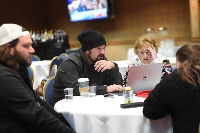 Activist Robert Beadles, middle, watches results on the midterm election during a Washoe County GOP watch party at Boomtown Casino near Reno on Nov. 8, 2022. Melissa Lopez is seen on his right.