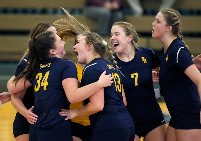 The Siena Heights volleyball team celebrates a set win during Wednesday's WHAC tournament quarterfinal against Aquinas.