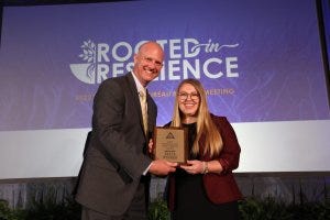 President Jeb S. Smith presents Maddie Dvorak with her award for winning the Collegiate Discussion Meet at the Florida Farm Bureau Annual Meeting in Orlando.
