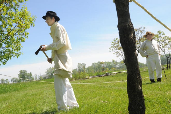 Nathan Seger of LaSalle, then 16, gets ready to throw a tomahawk as Ralph Naveaux looks on during a River Raisin National Battlefield Park open house in 2011. The Battlefield’s inaugural Tomahawk Challenge will take place Thursday.