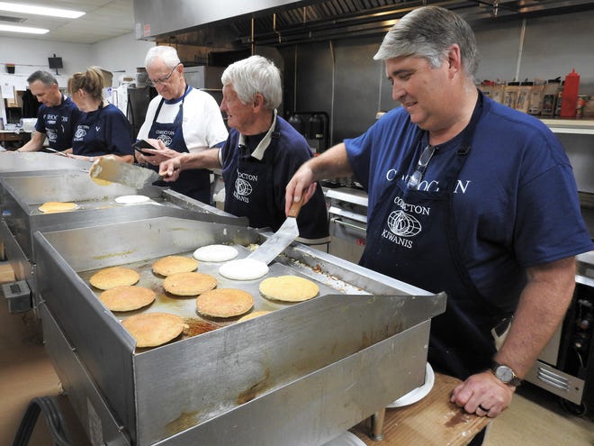Charles Fornara, Maureen Karl, Stan Zurowski, Jerry Stenner and Max Crown of the Coshocton Kiwanis Club work the pancake line for the club's annual pancake day Thursday at the Coshocton Elks Lodge. About 1,500 people are served on average with $7,000 to $9,000 raised for local service projects.