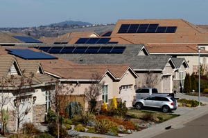 Solar panels sit on rooftops at a housing development in Folsom, Calif., Wednesday, Feb. 12, 2020.